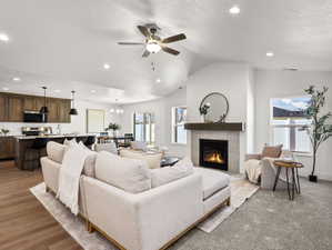 Living area featuring a gas fireplace with a tile surround and wood mantel