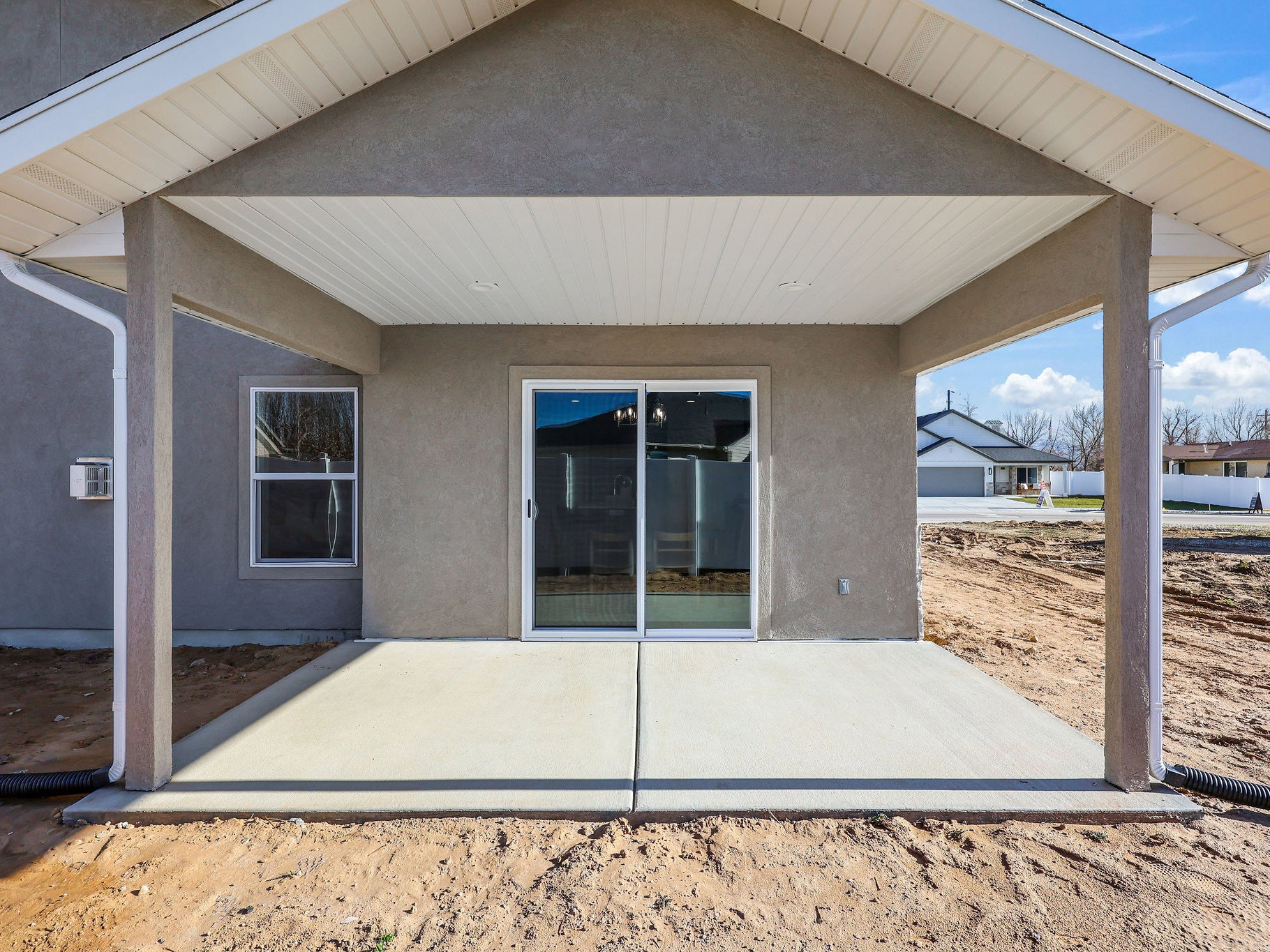 Covered patio featuring a concrete slab and sliding glass door access