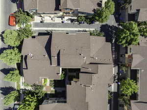 Aerial perspective showcasing a residential complex with multiple brown-shingled rooftops