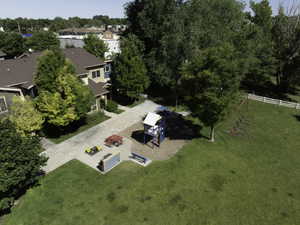 Expansive green space featuring a playground with a slide structure and a separate swing set