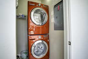 Dedicated laundry closet featuring a stackable washer and dryer unit