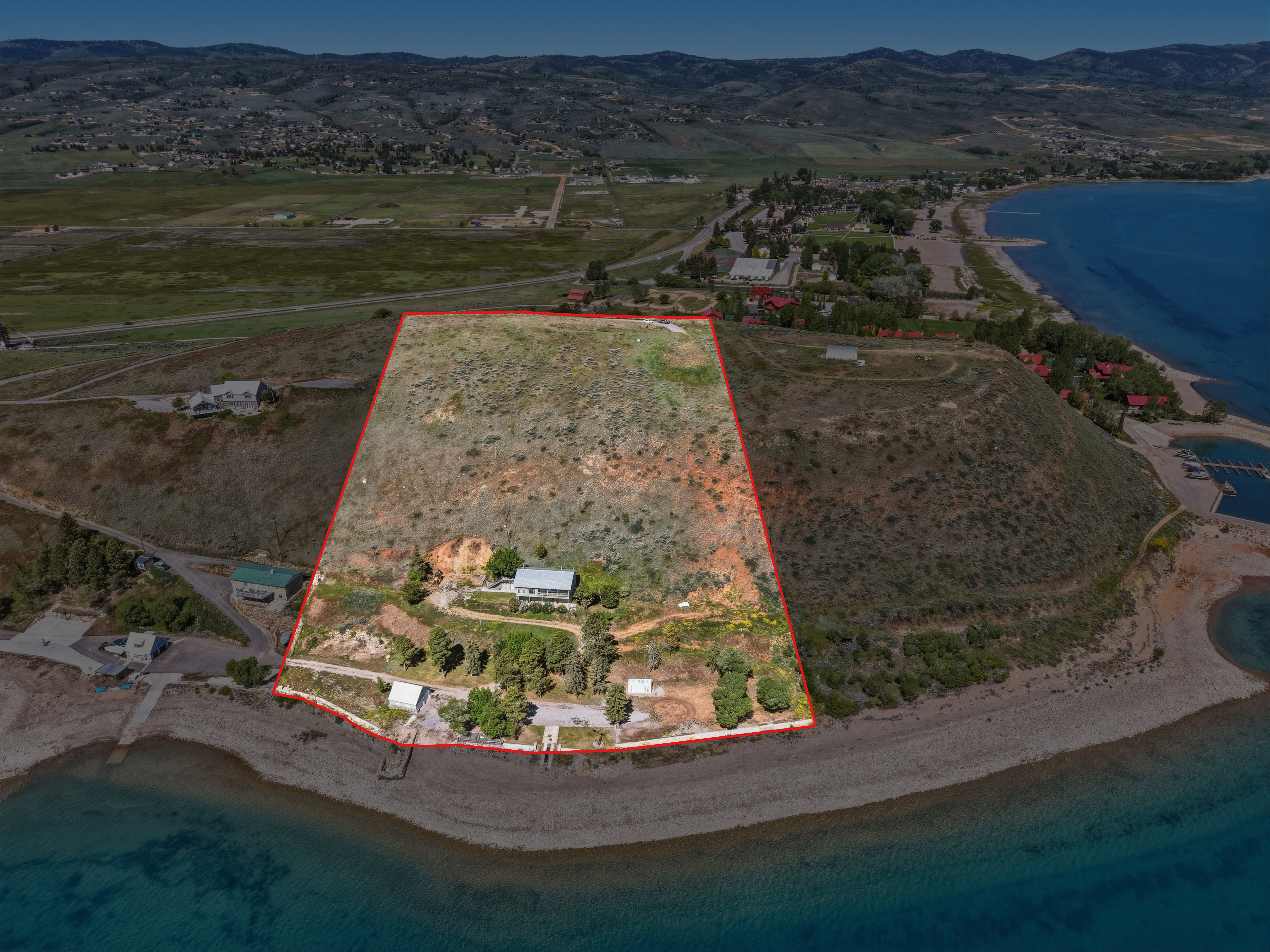 Expansive lakefront property featuring a private beach and direct water access