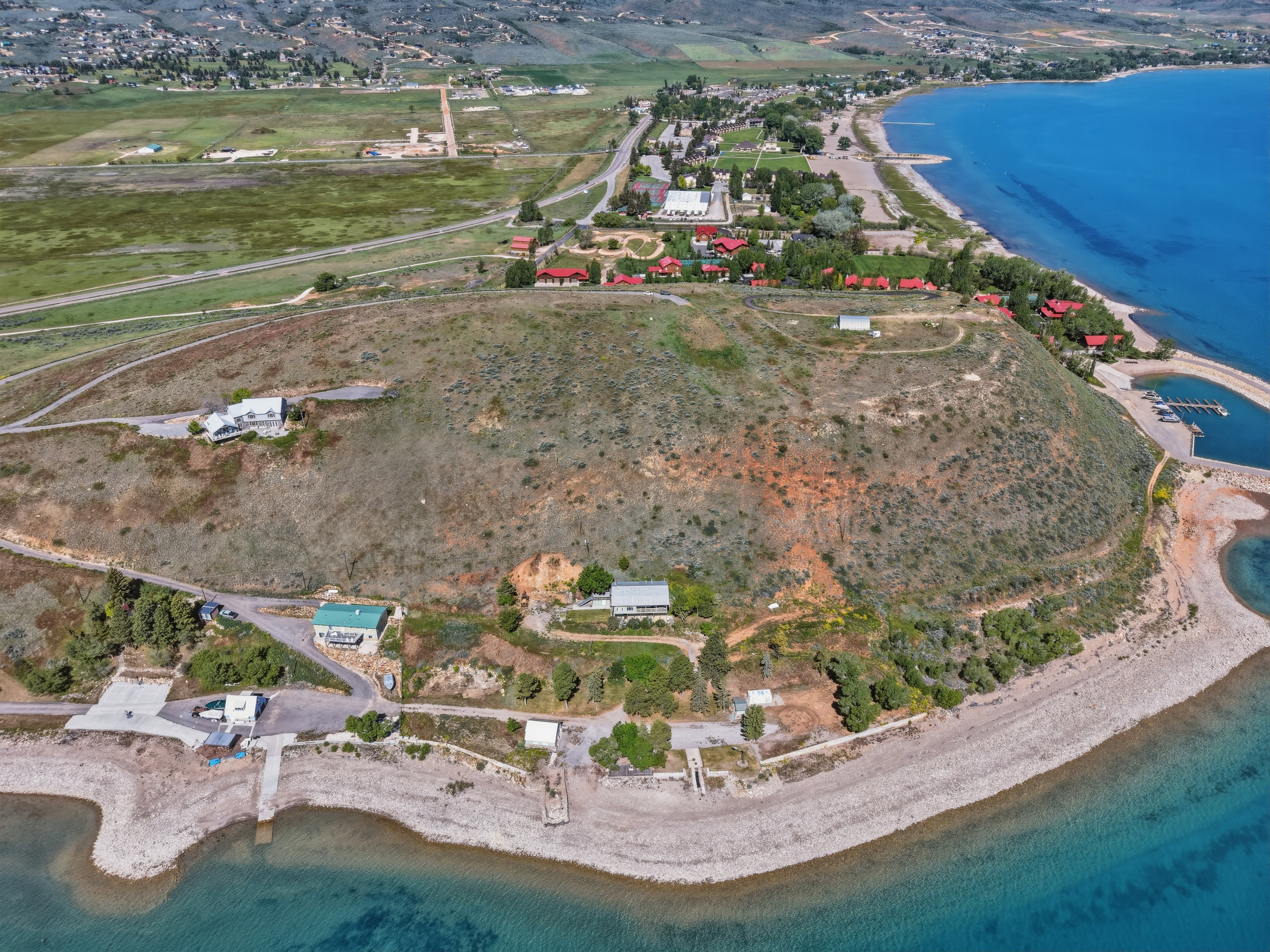 Aerial perspective showcasing multiple waterfront properties along a large body of water