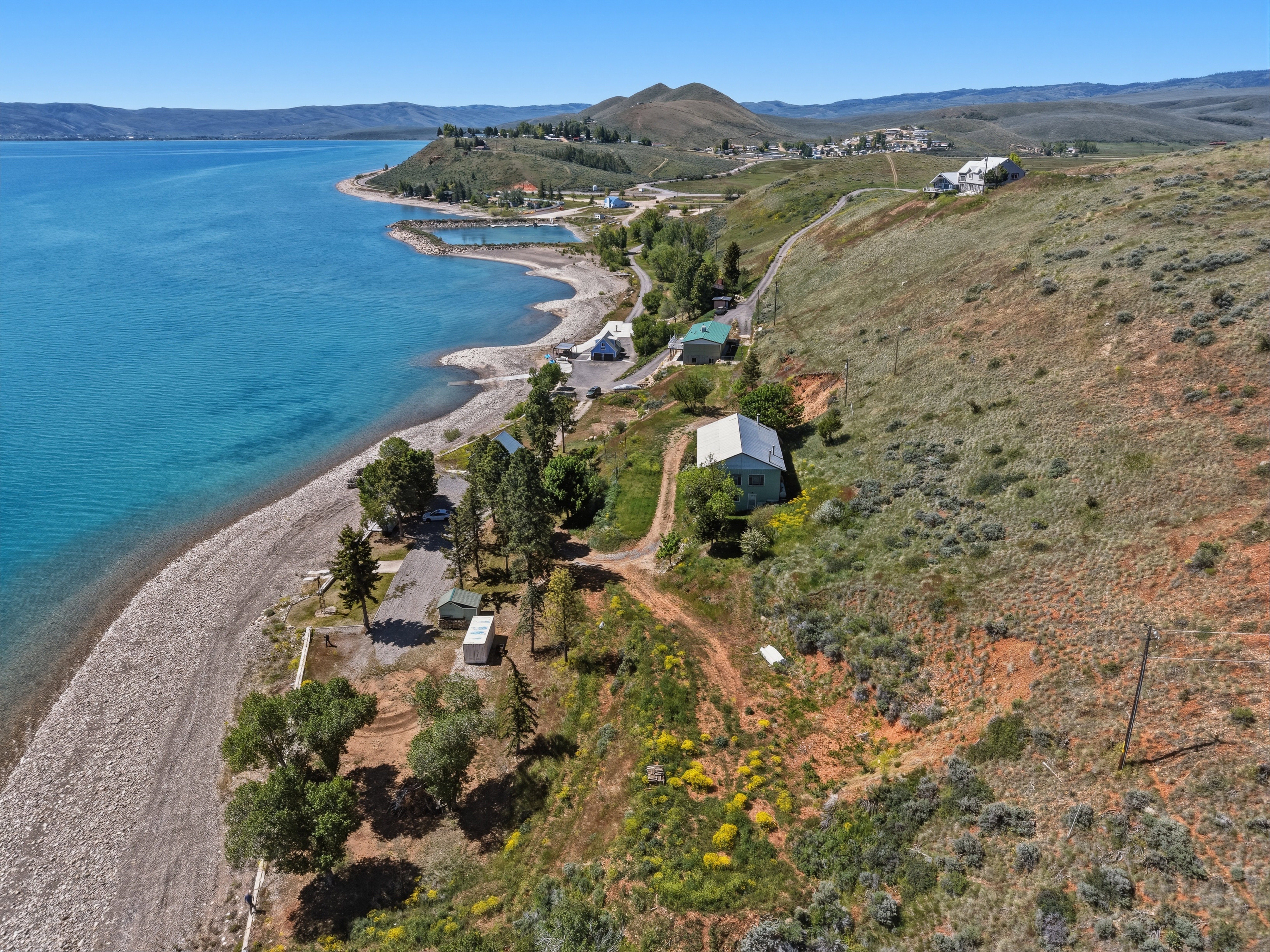Waterfront property featuring extensive shoreline frontage, direct water access, and a diverse landscape of natural terrain