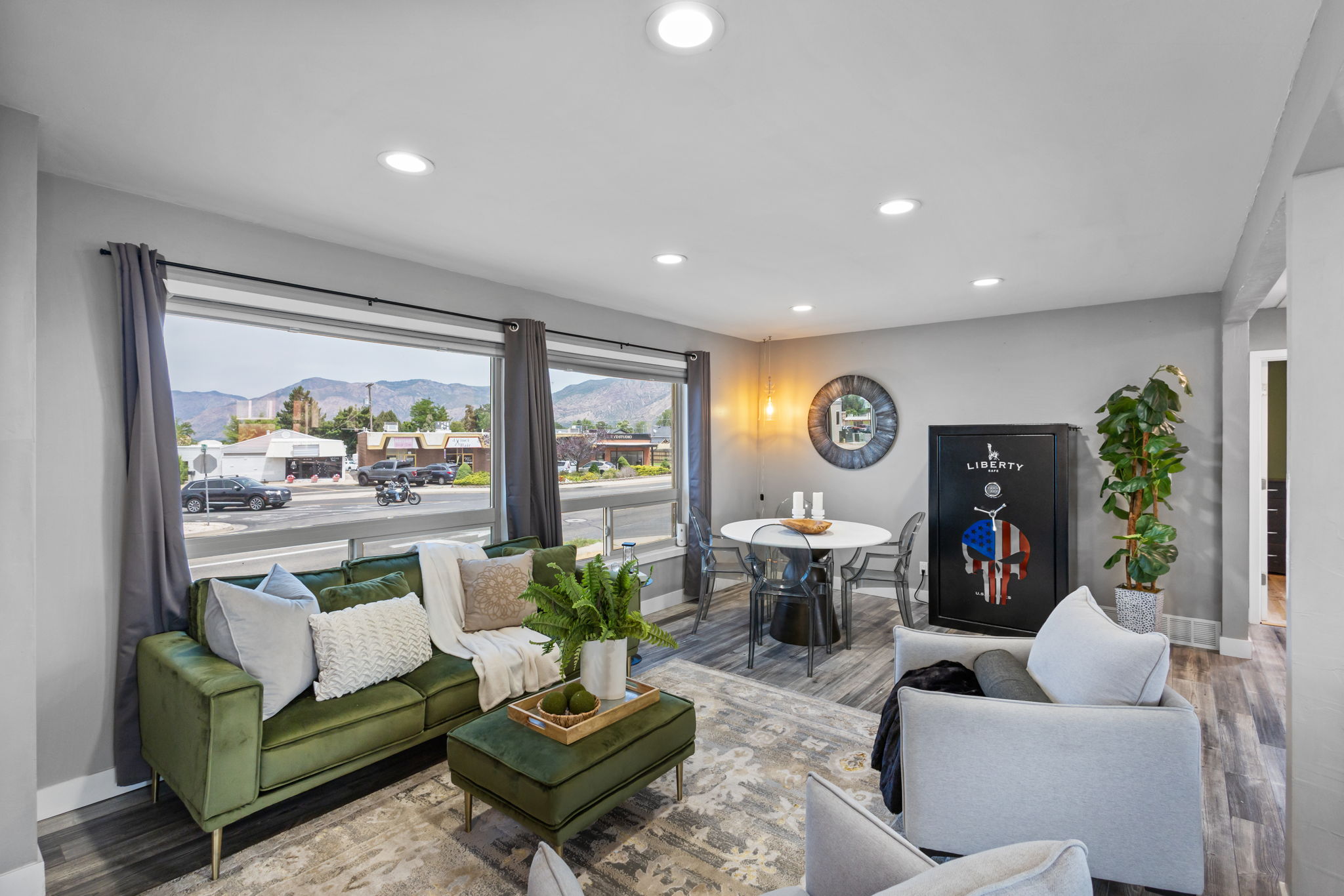 Open concept living space featuring recessed lighting, wide plank wood-finish flooring, and a large picture window