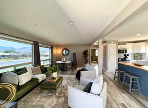Expansive living area featuring large windows, recessed lighting, and wood-finish flooring