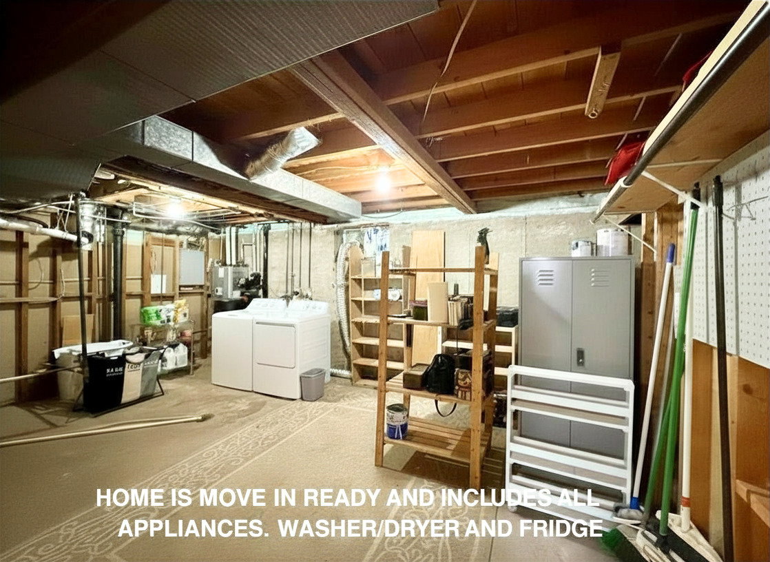 Utility space featuring exposed wood joists and concrete foundation walls