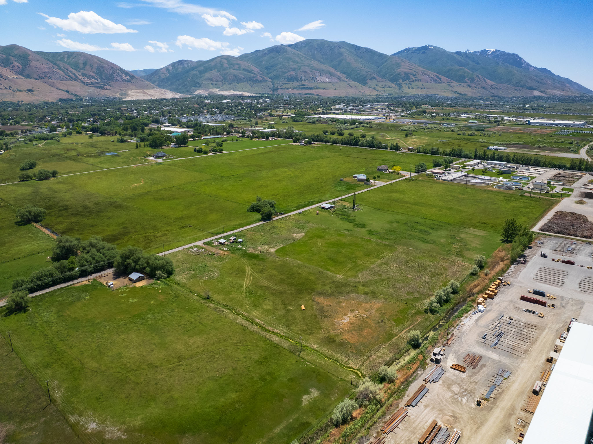 Expansive green fields with distant mountain range