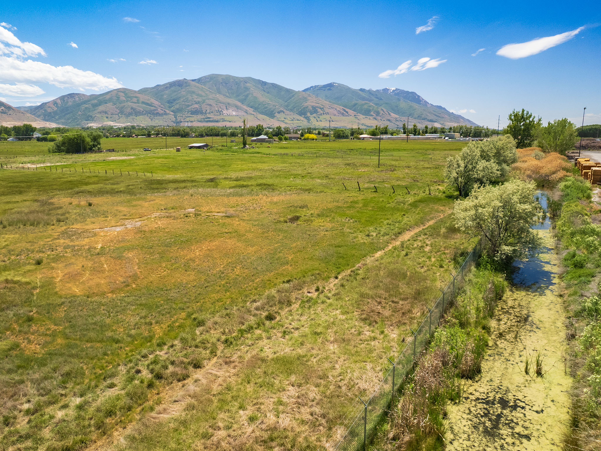 Expansive green acreage with distant mountain scenery