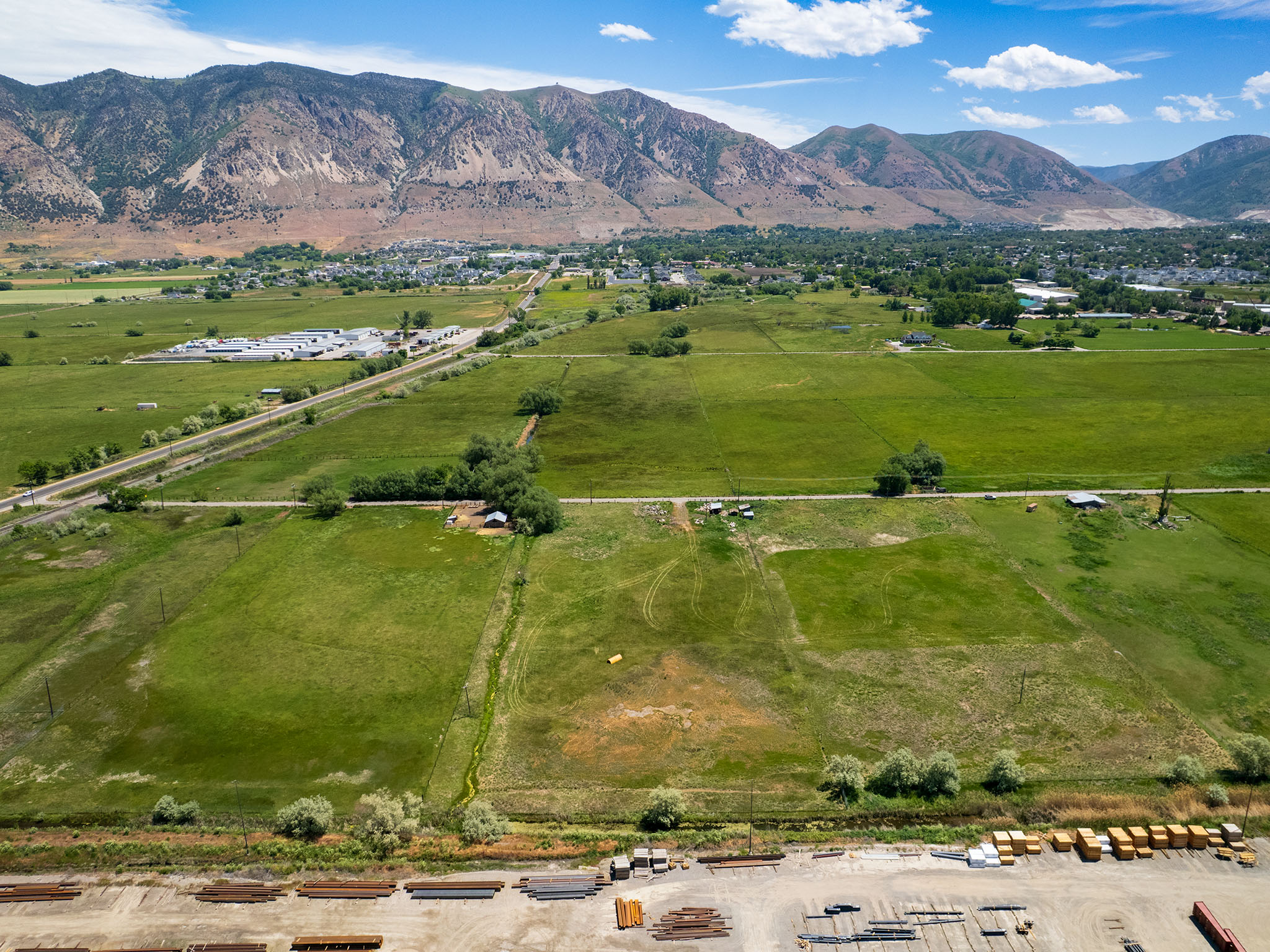 Expansive green fields with a mountain backdrop