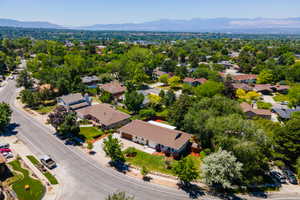 Expansive residential neighborhood featuring mature trees and mountain scenery