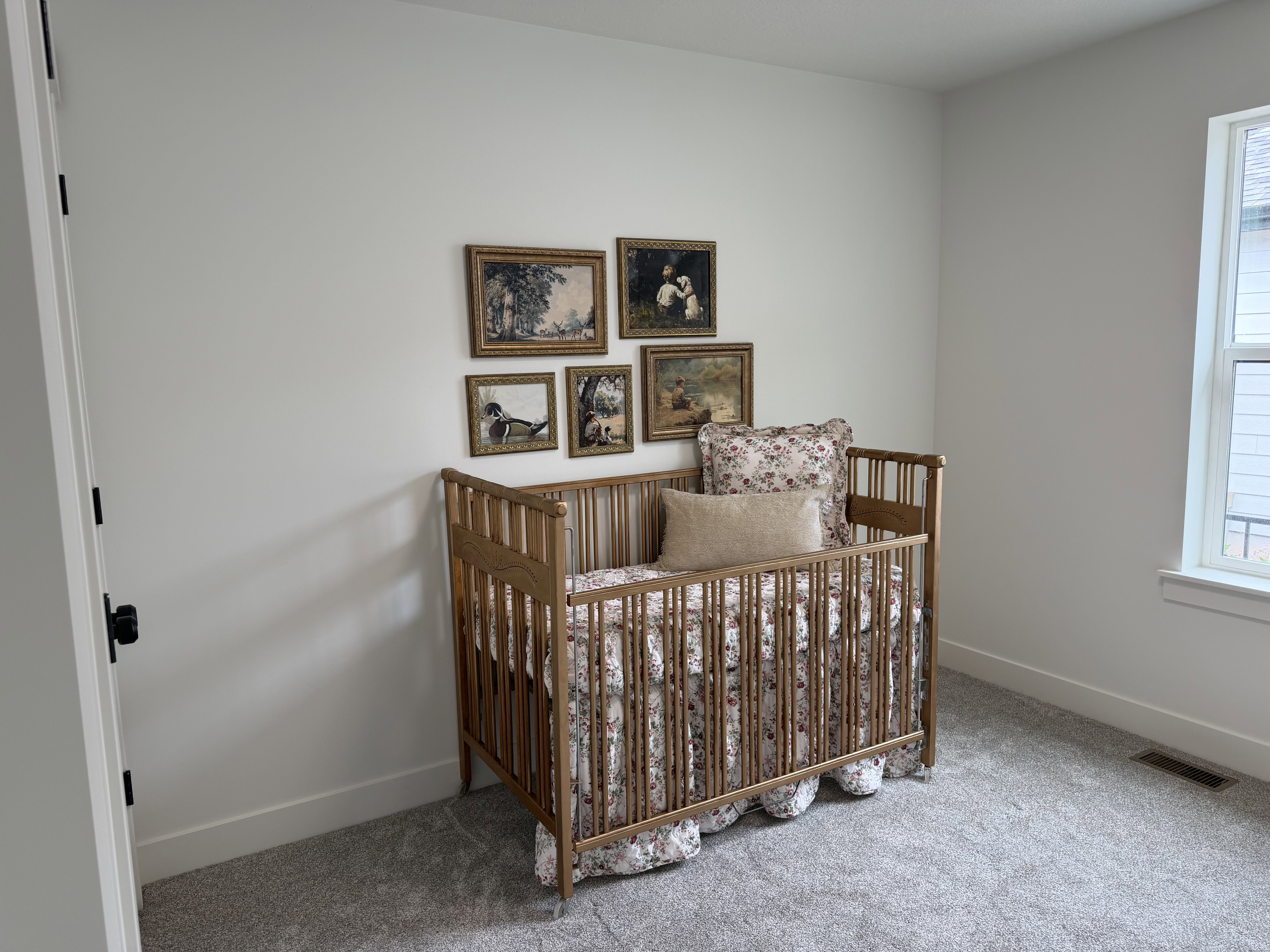 Bedroom featuring light gray carpeting, white walls, and a white trim package