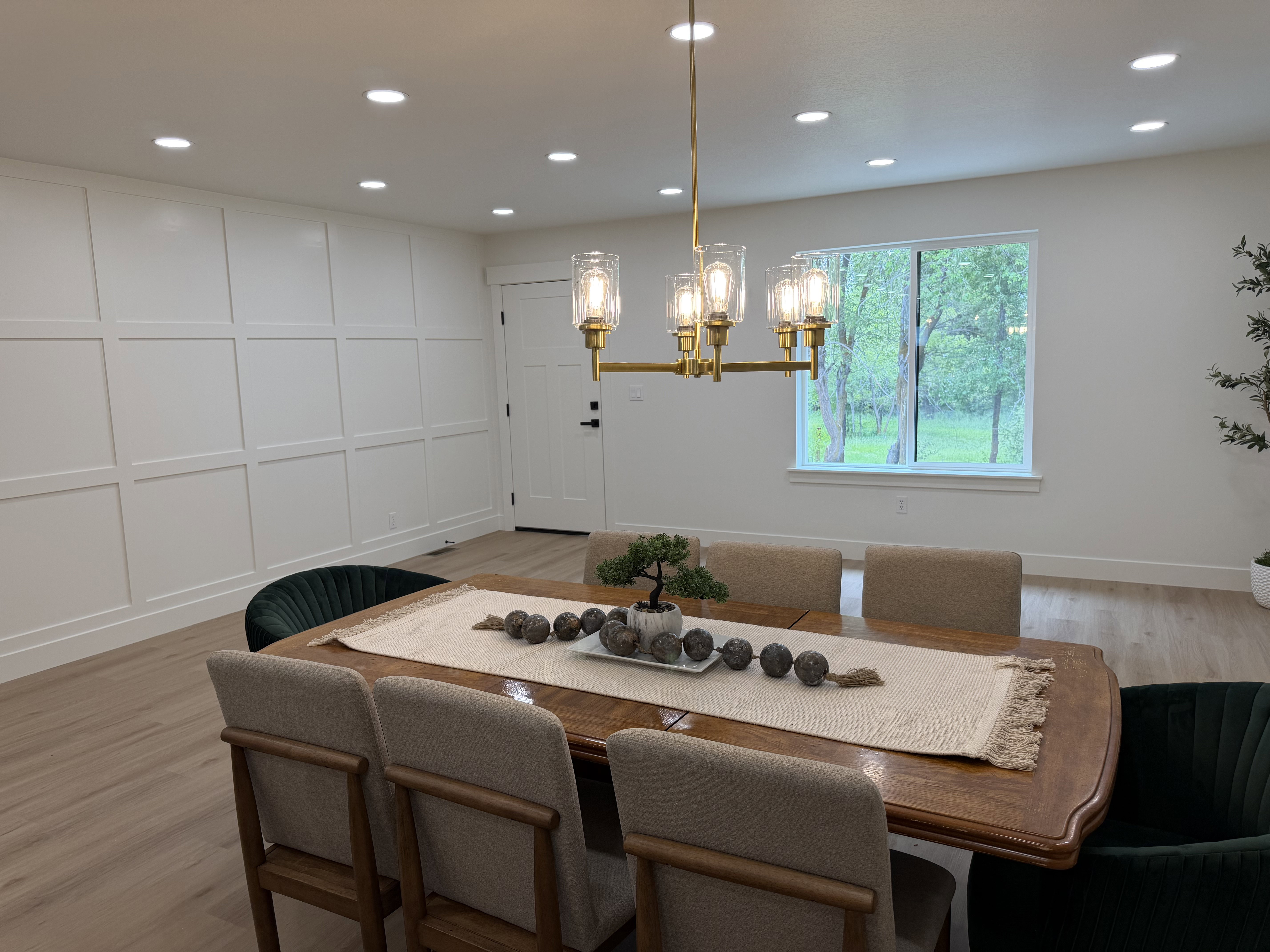Dining space featuring a gold-finish linear chandelier, recessed lighting, and light wood-finish flooring