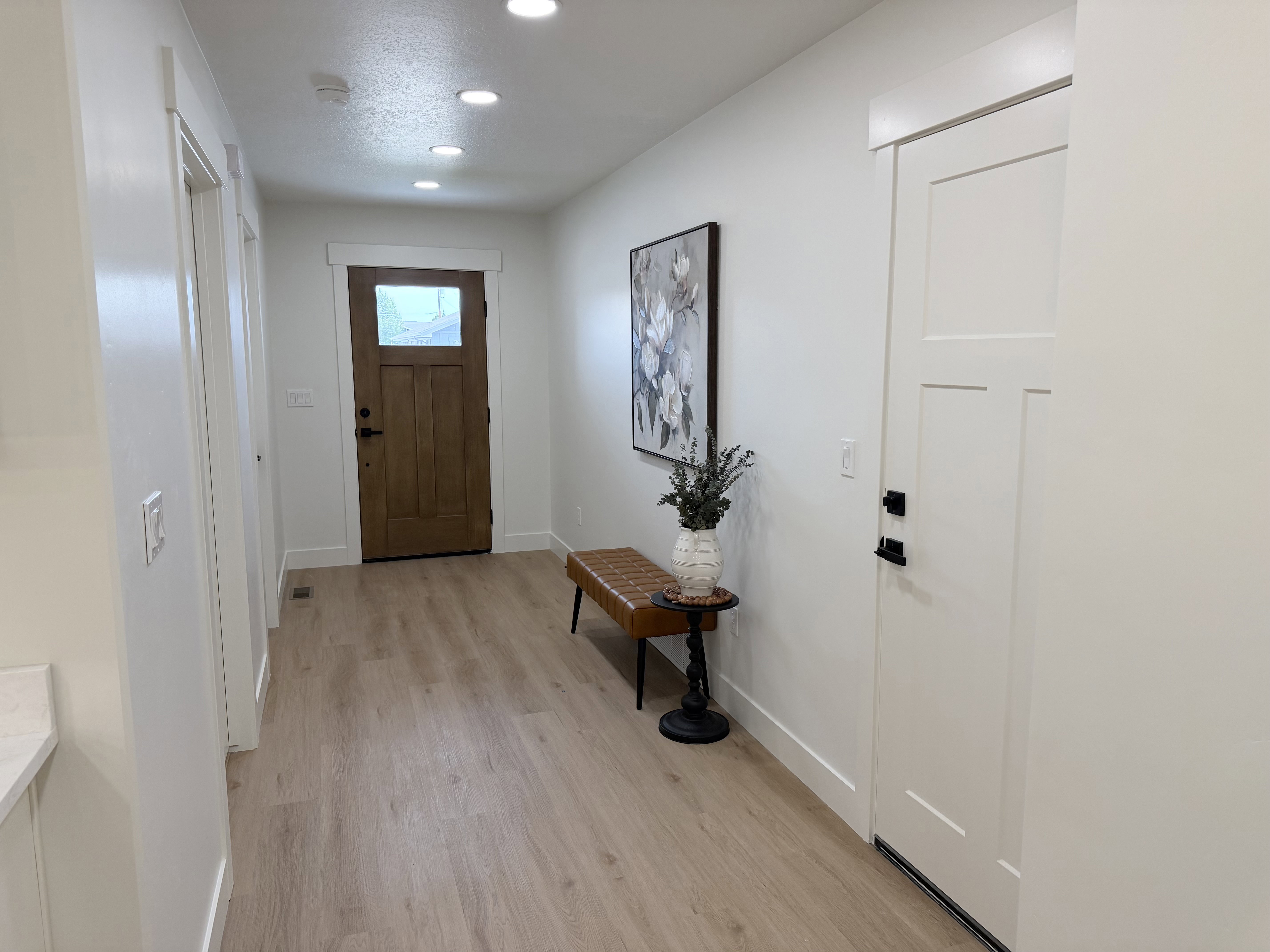 Entryway featuring light wood-finish flooring, recessed lighting, and a solid wood front door with frosted glass paneling
