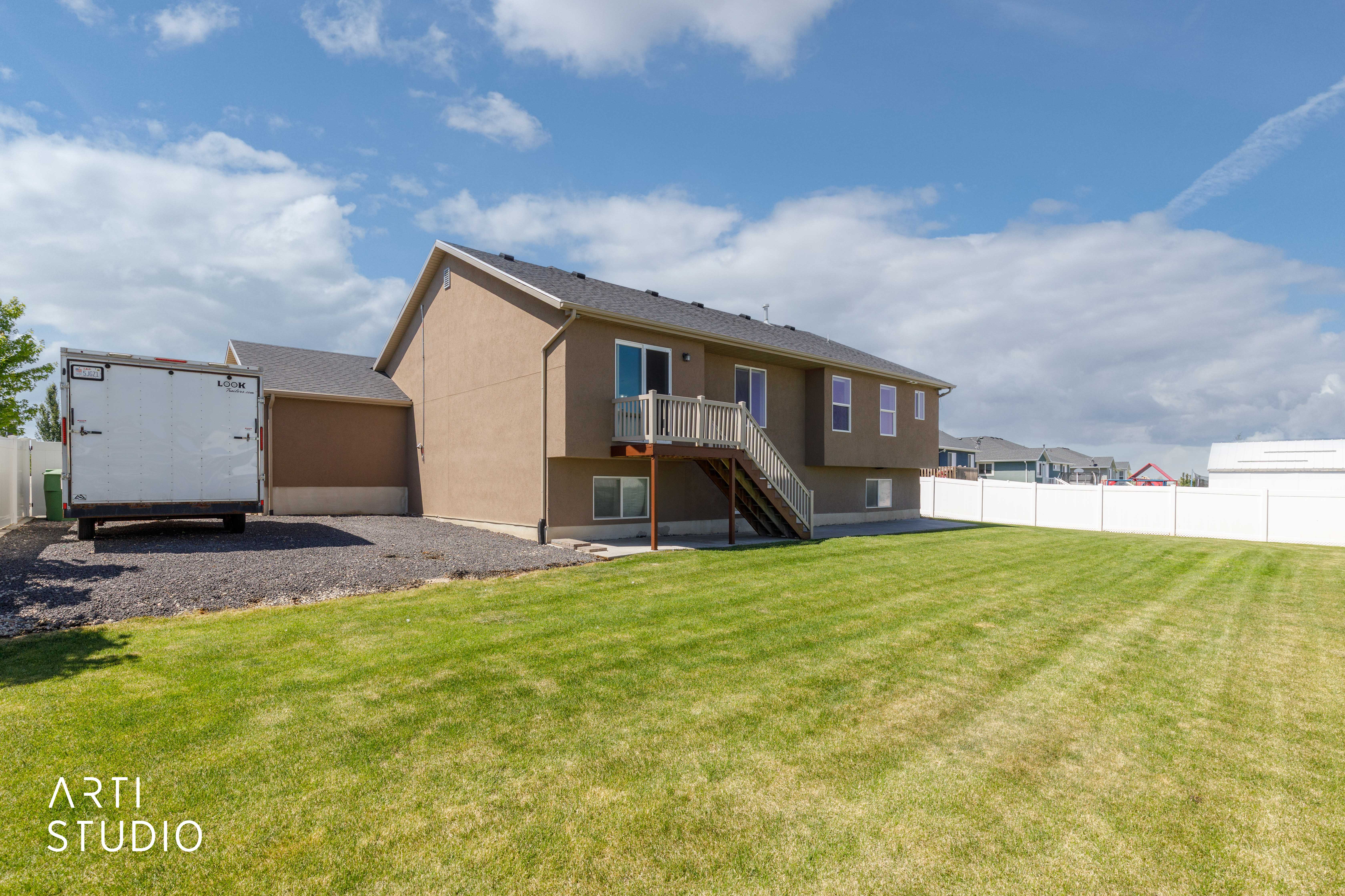 Expansive green lawn with a vinyl privacy fence