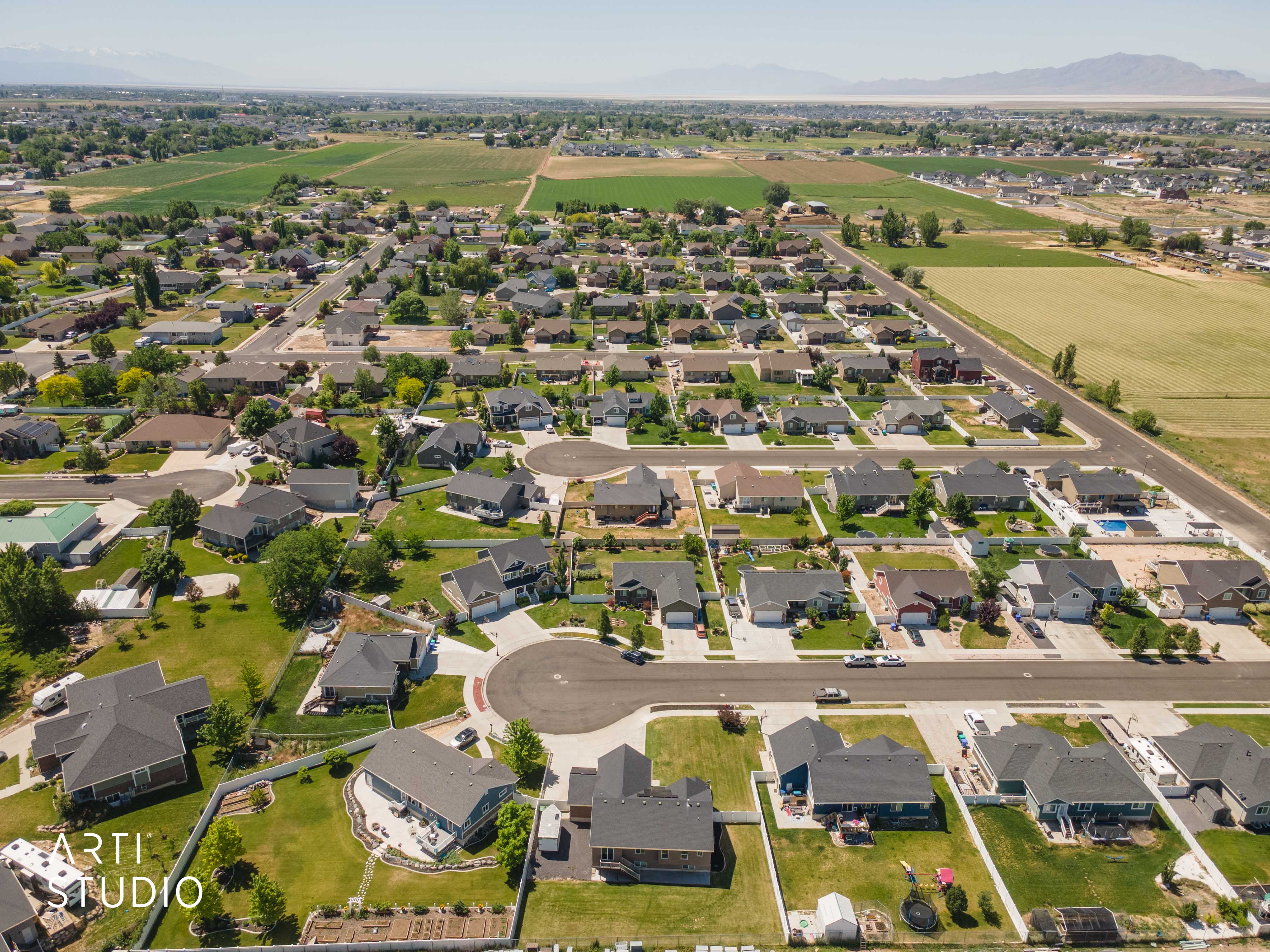 Aerial perspective showcasing a residential community with varied home styles and expansive green spaces