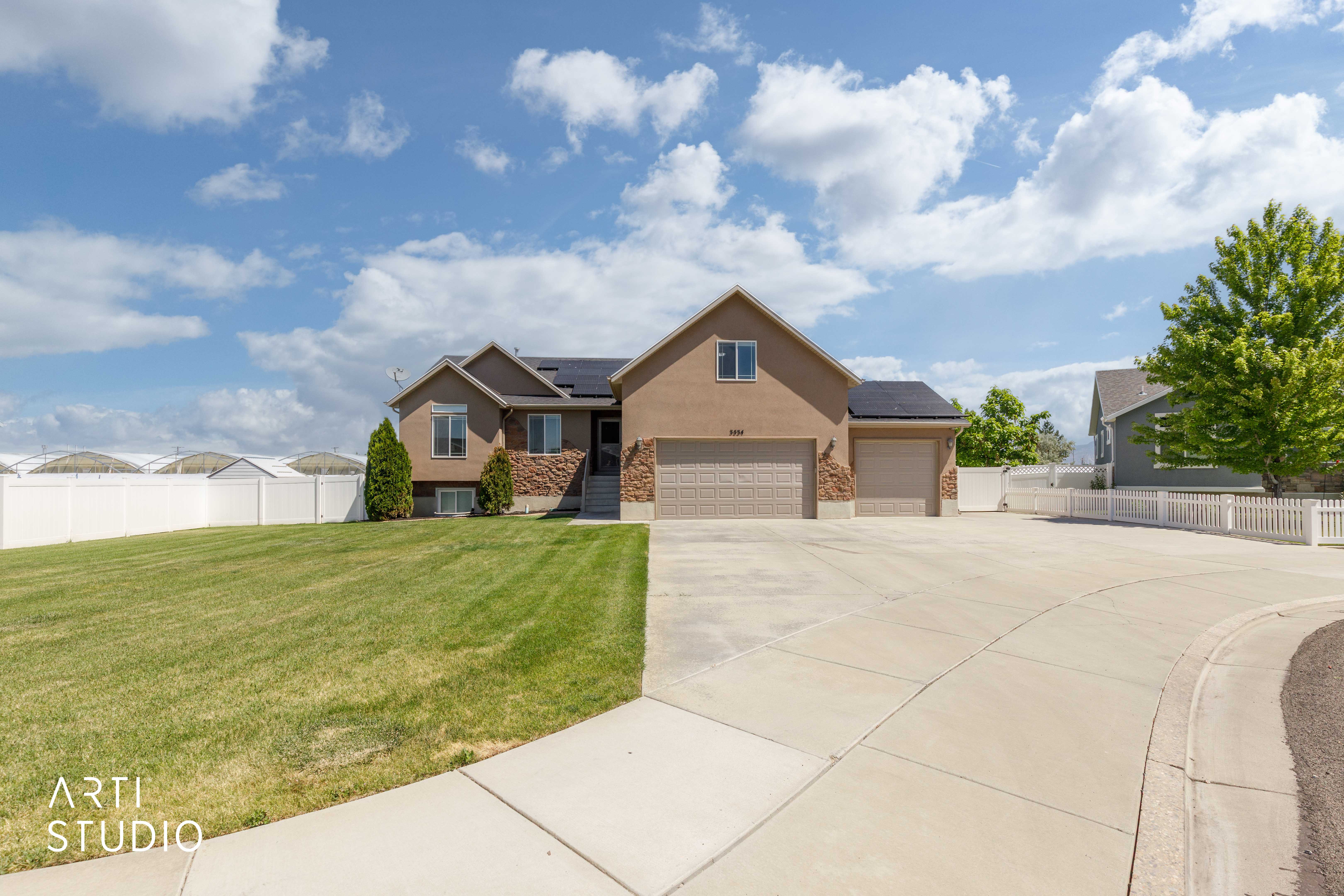 Contemporary-style residence featuring a two-car garage and a paved driveway