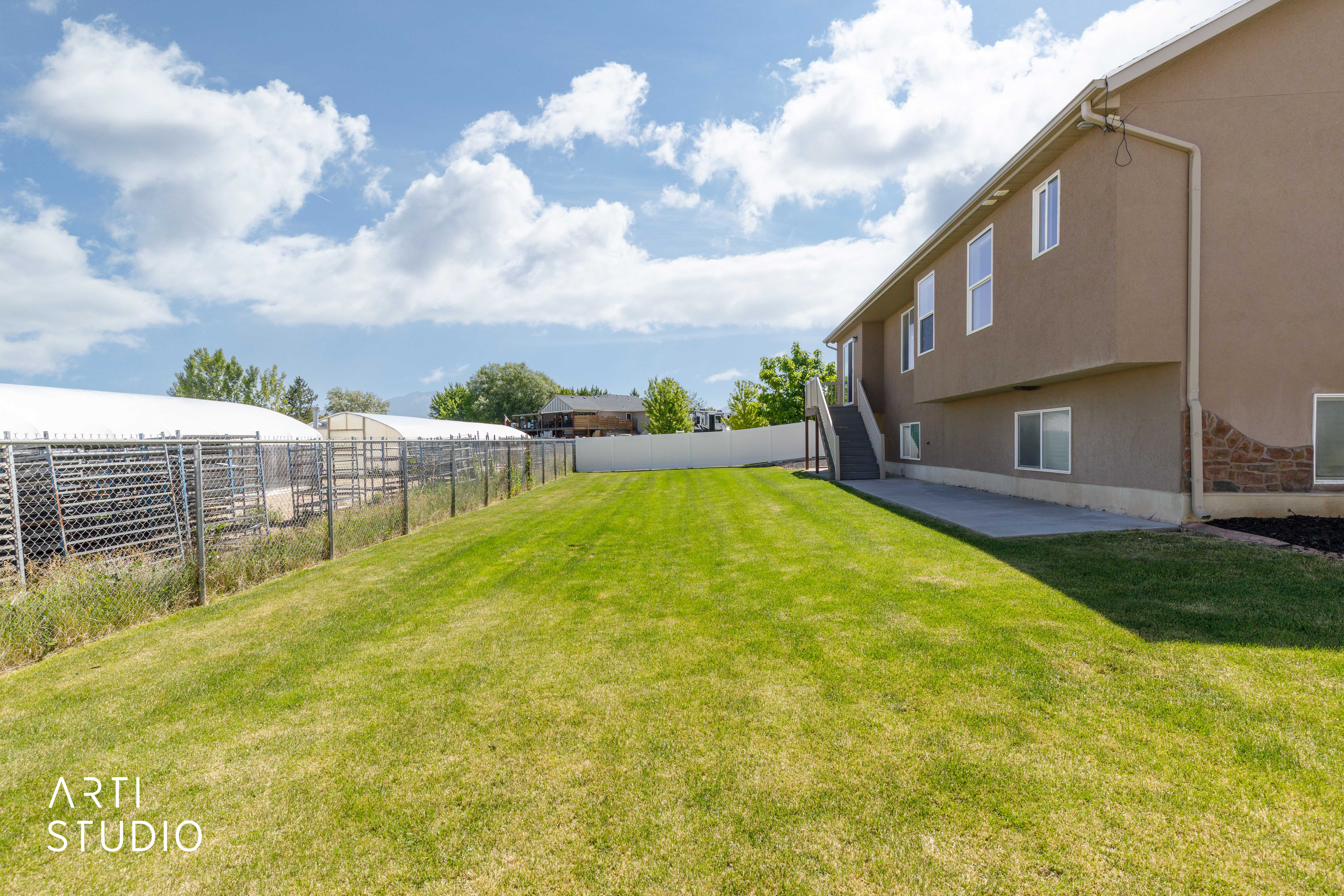 Expansive green lawn extending from the residence