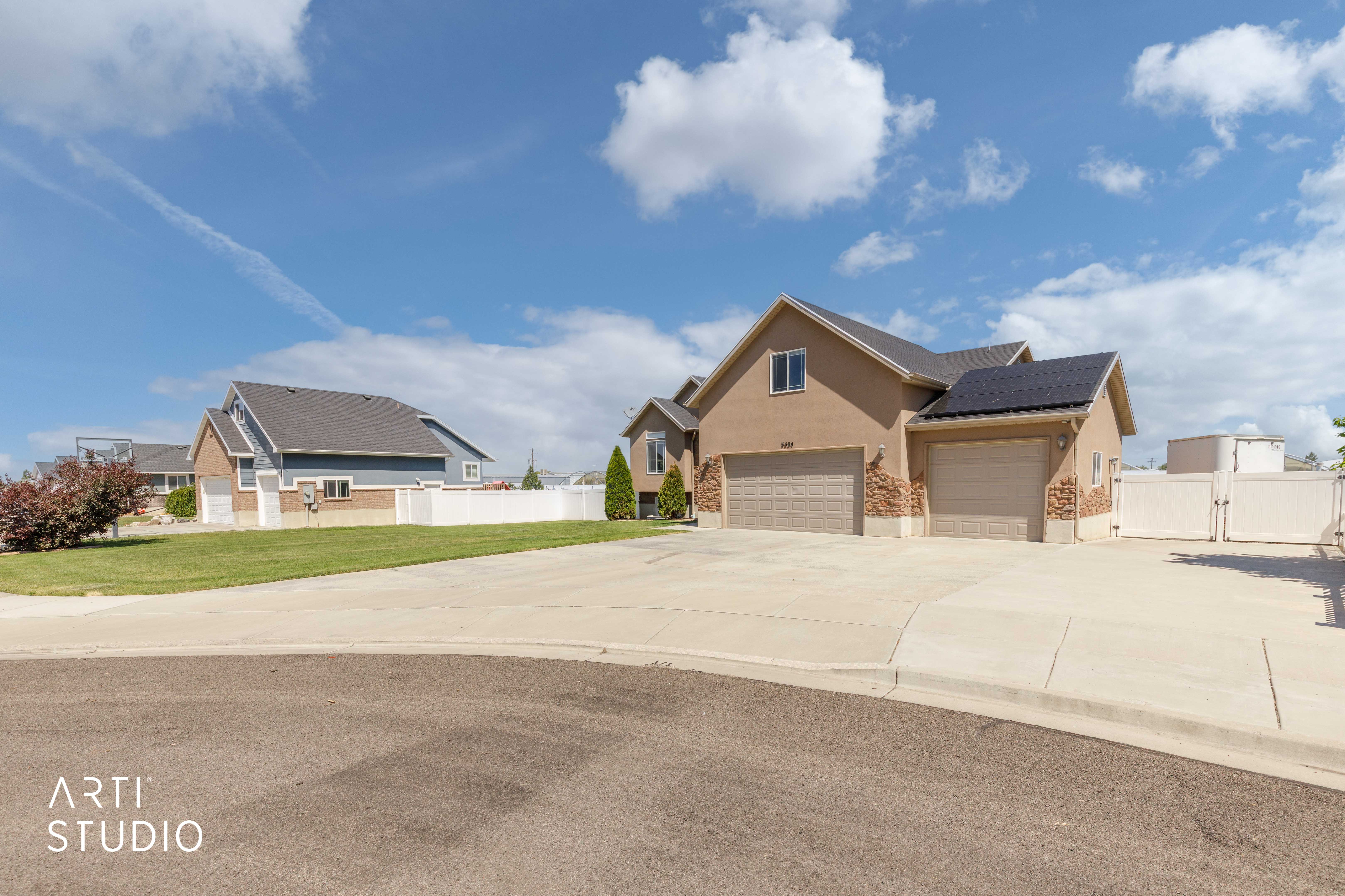 Stucco exterior with stone accents and an attached two-car garage