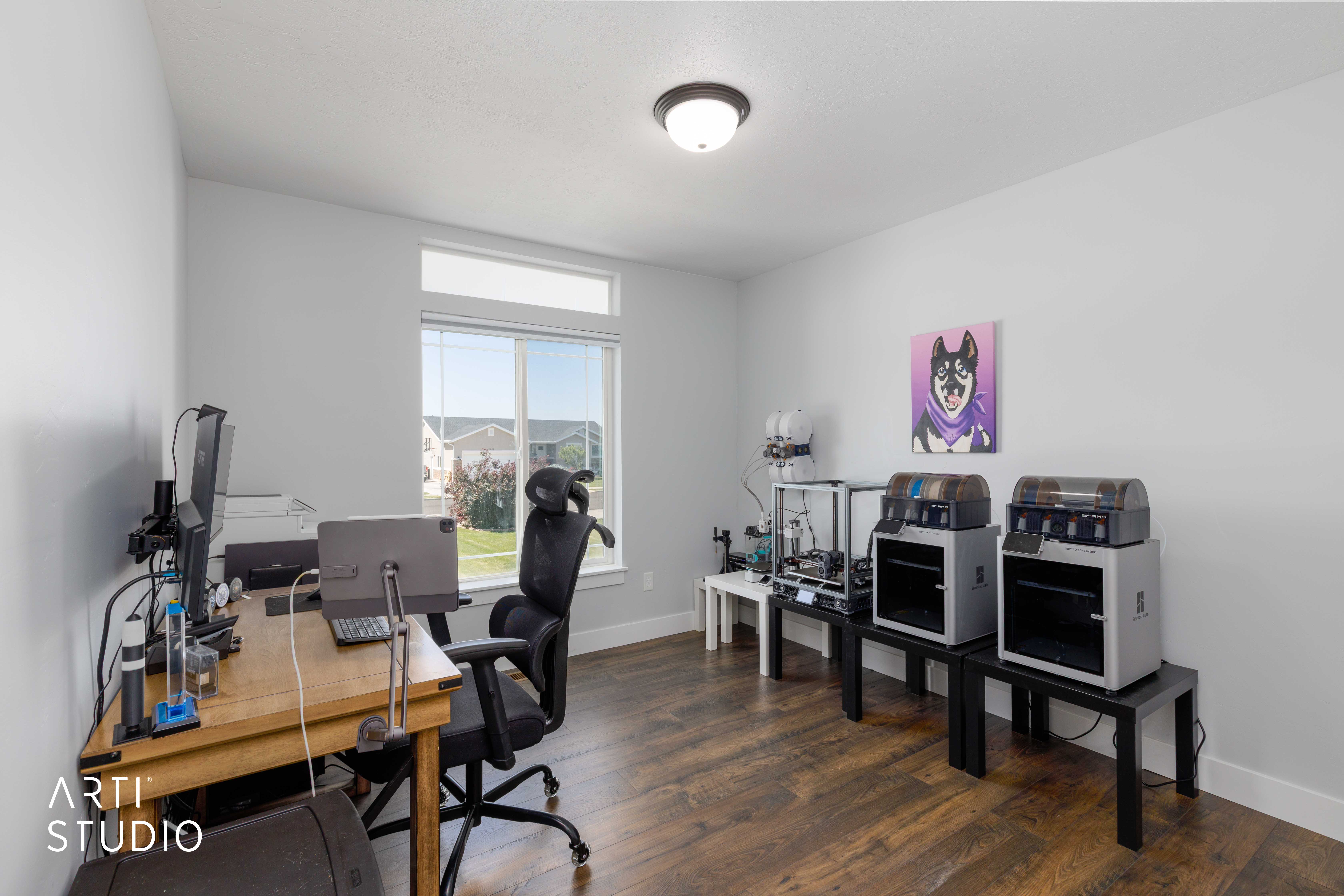 Versatile interior space featuring wood-finish flooring, light-toned walls, and a large window with an upper transom
