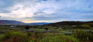 Expansive mountain and valley landscape with distant water features