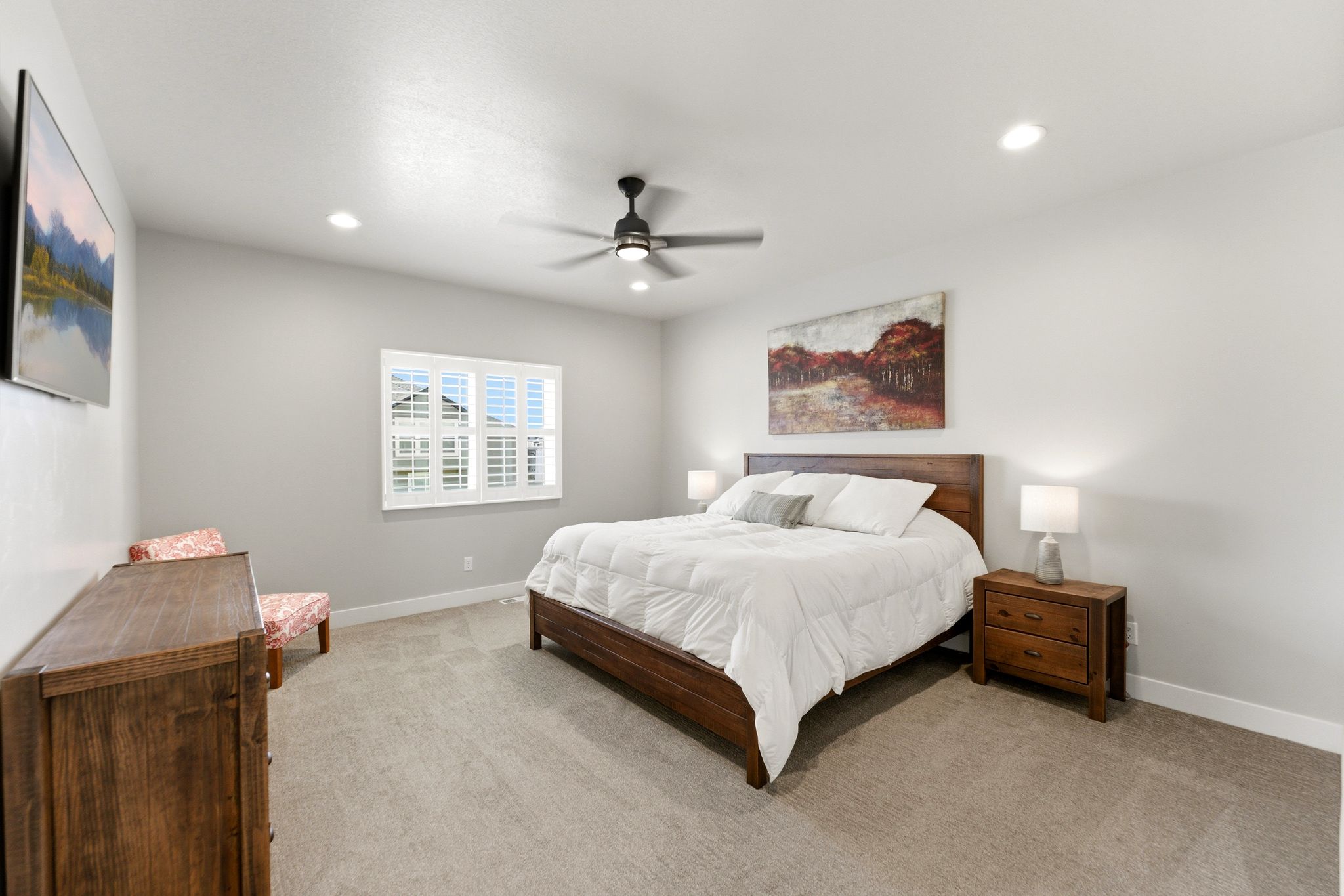 Spacious primary bedroom with fan and ensuite bathroom.
