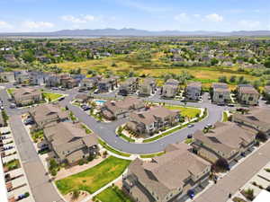 Aerial view of a residential community featuring varied architectural styles and a mountain backdrop