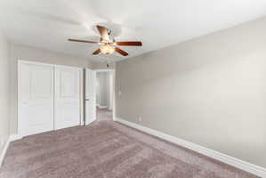 Carpeted interior room with neutral wall tones