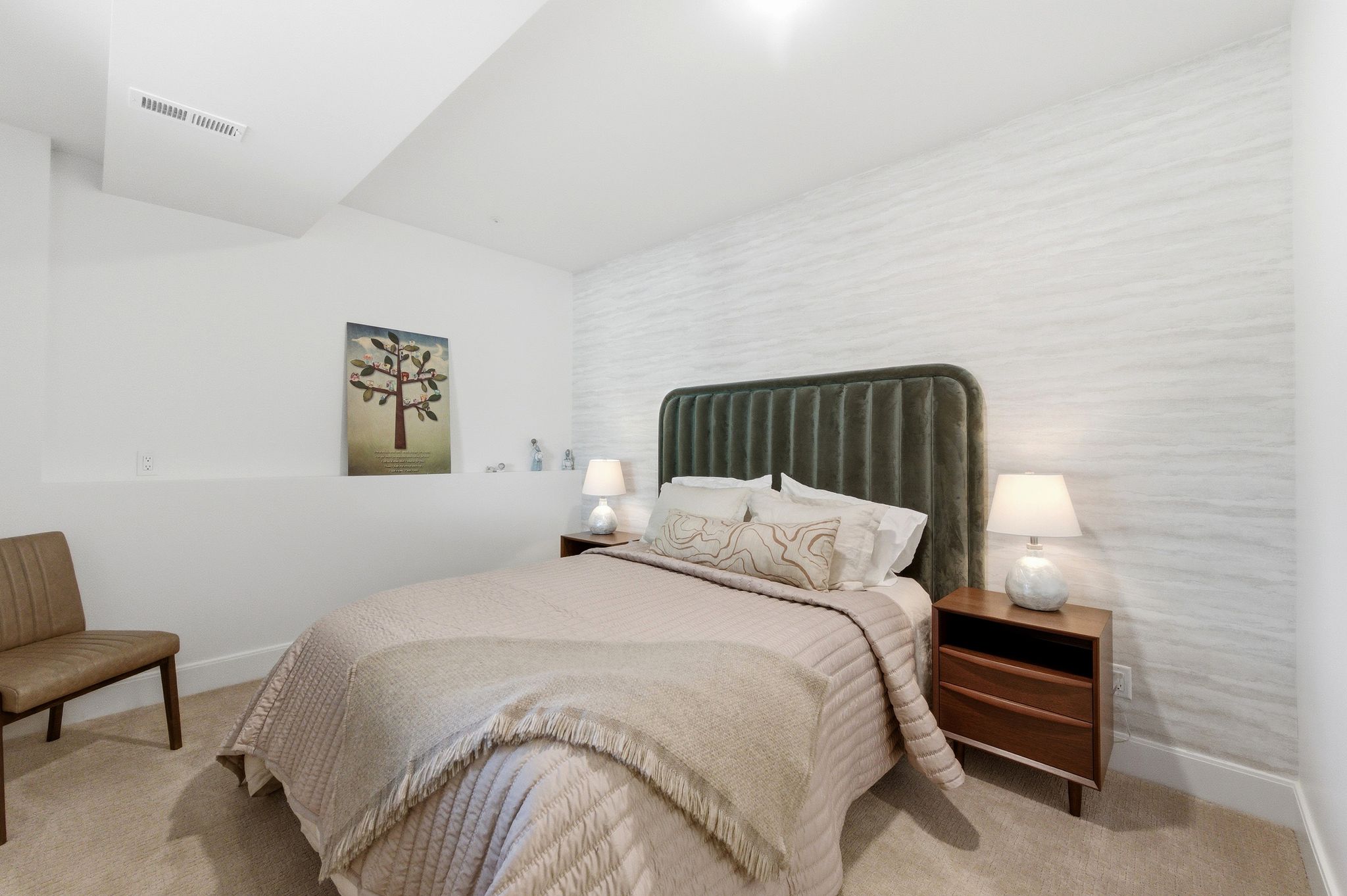 Carpeted bedroom featuring a textured accent wall, recessed lighting, and a built-in wall niche