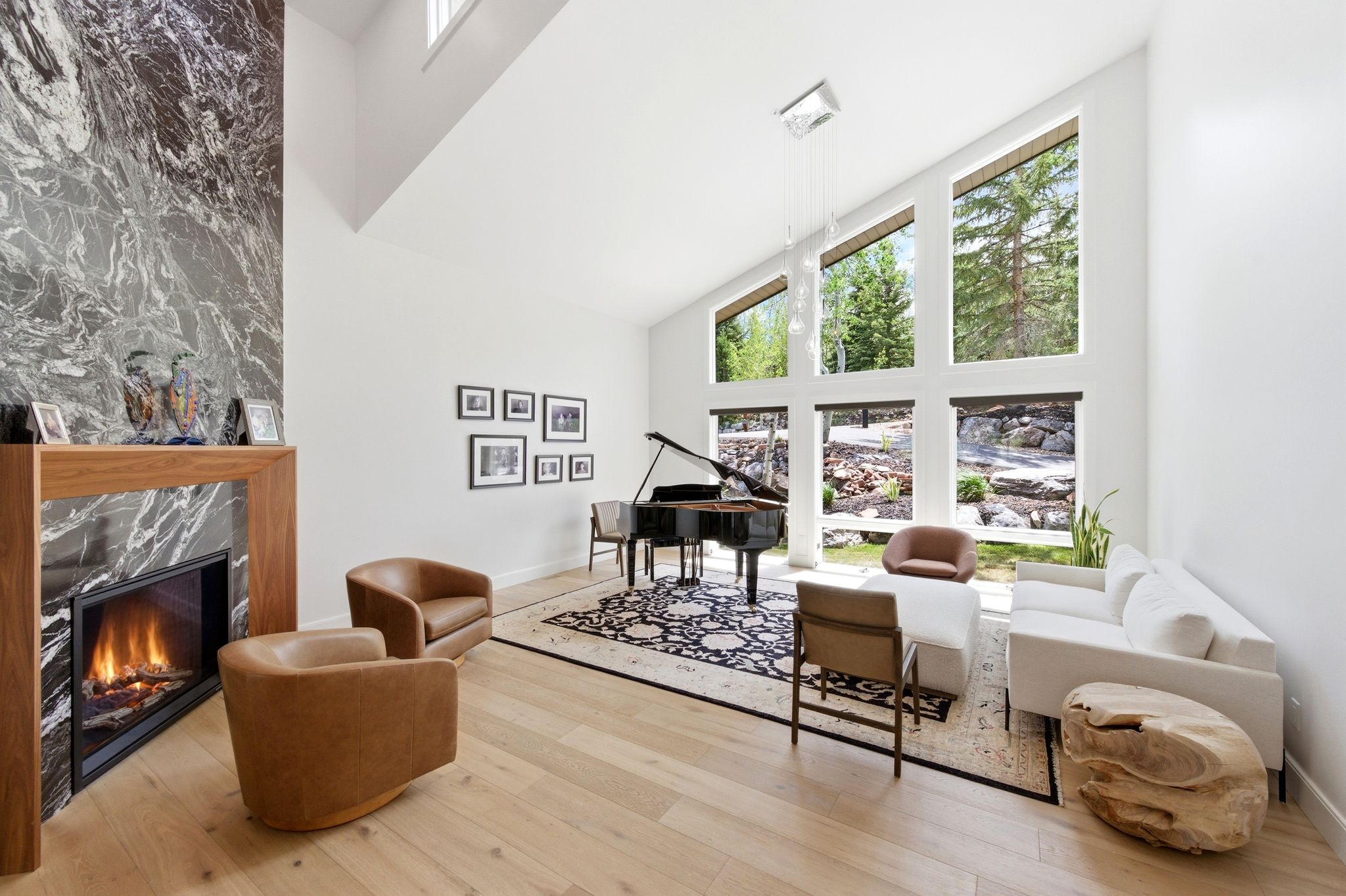 Living area featuring a floor-to-ceiling fireplace with a dark stone surround and wood mantel