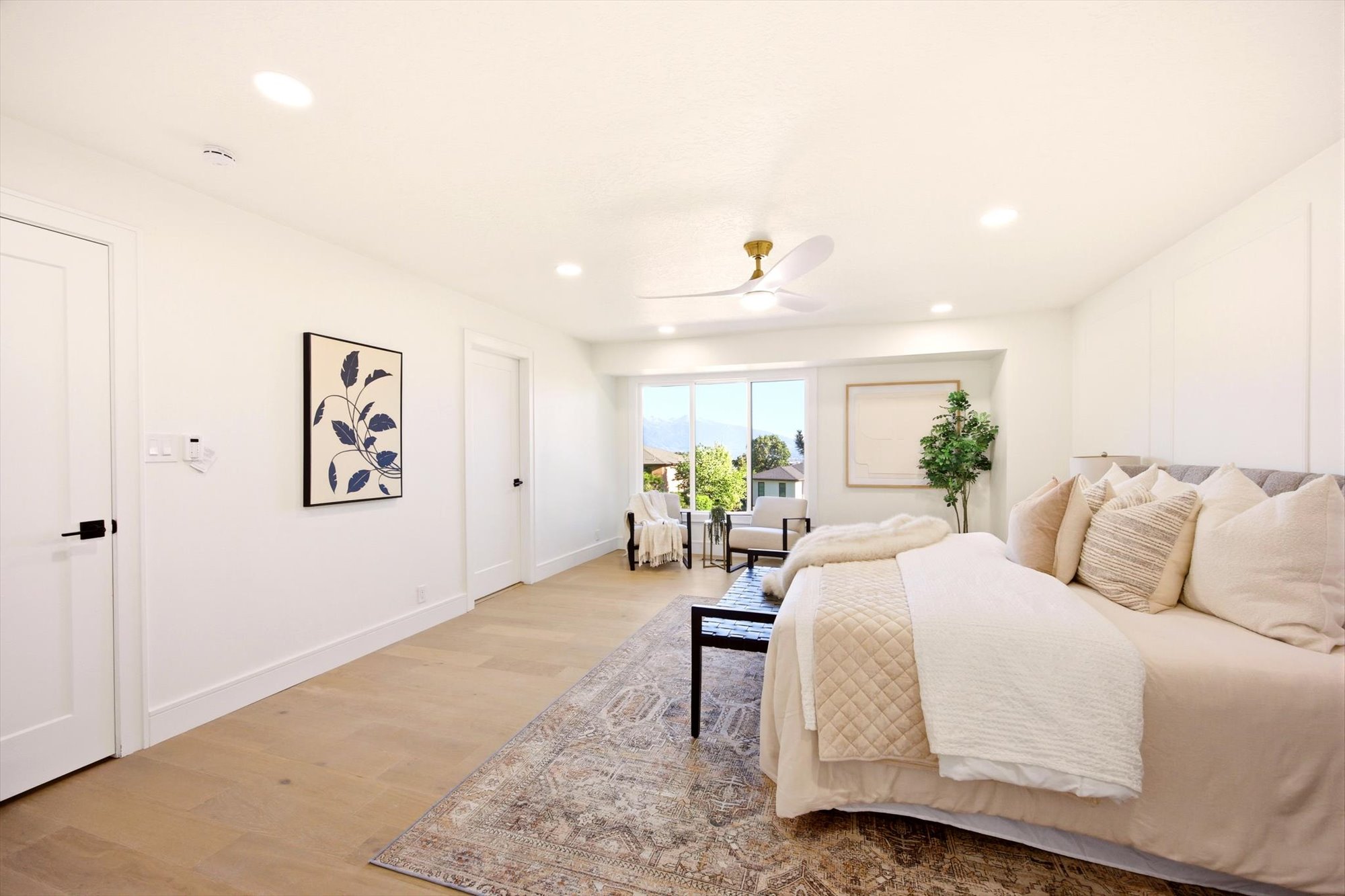 Spacious interior featuring wood-finish flooring, recessed lighting, and a contemporary ceiling fan