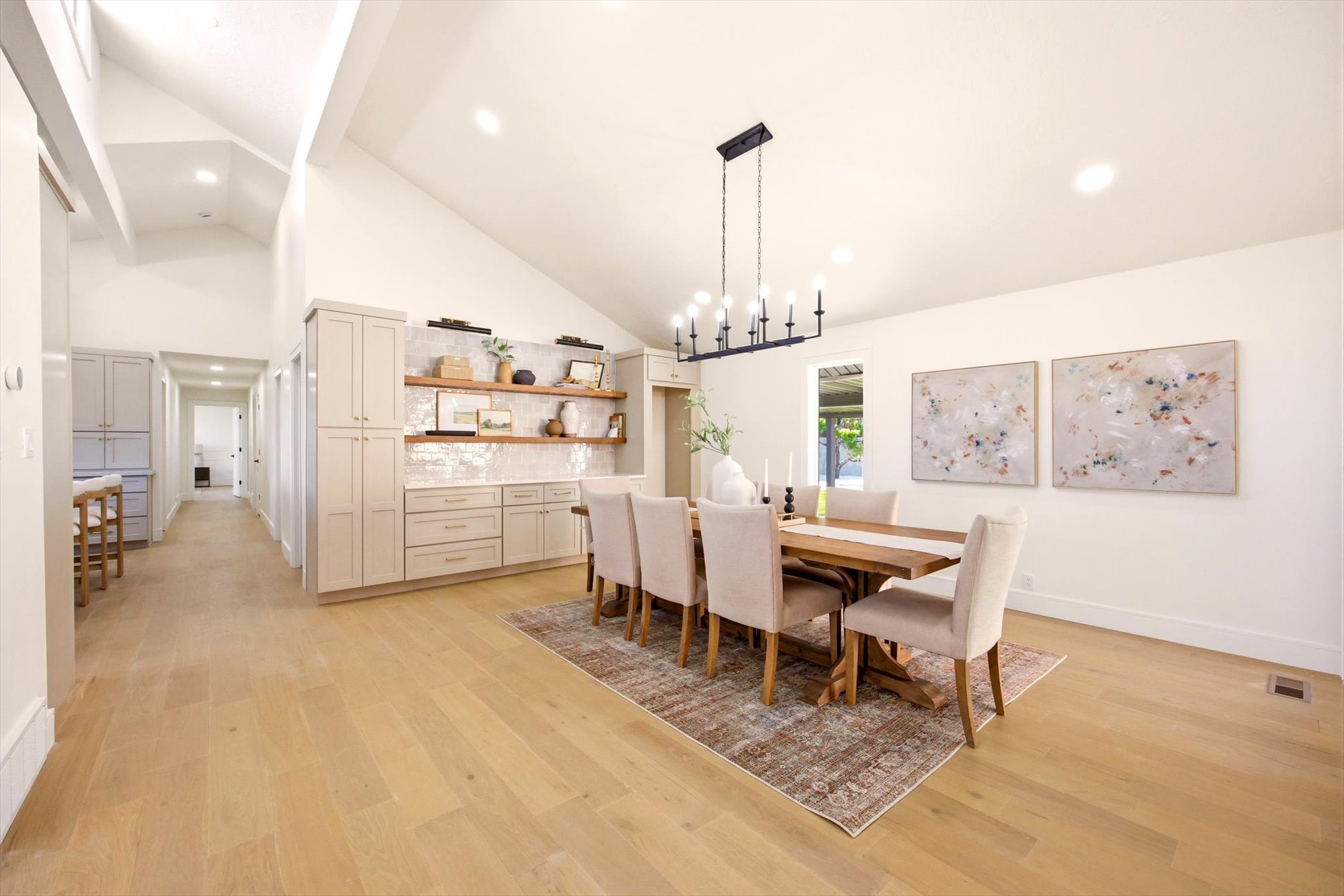 Dining area featuring vaulted ceilings with exposed beams and recessed lighting
