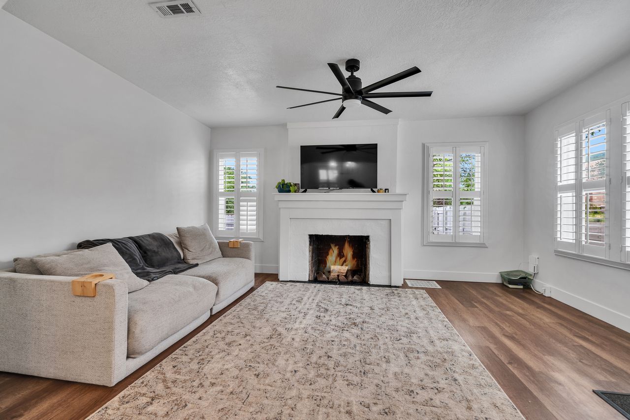 Front Living Room with Fireplace.  Plantation Shutters on the windows