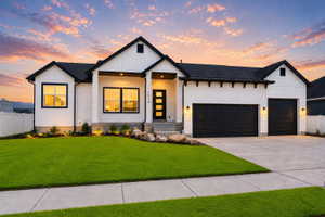 Modern farmhouse exterior with white vertical siding and black trim accents