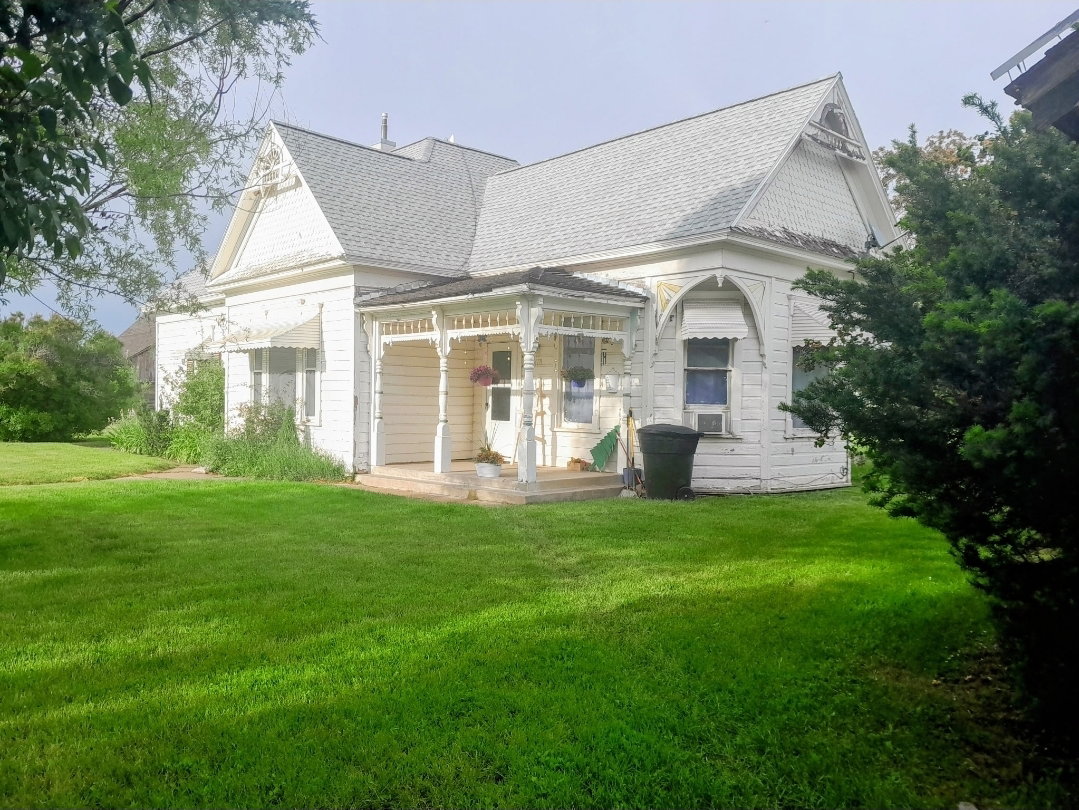 Classic white clapboard siding with decorative gables
