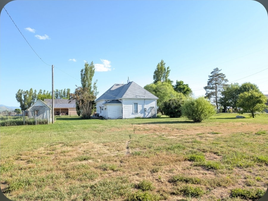 White single-story structure with a gray shingled roof