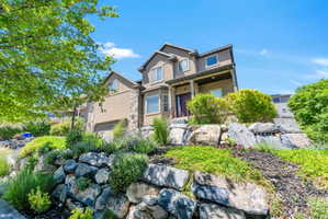 Multi-level exterior featuring a stucco facade and stone accents