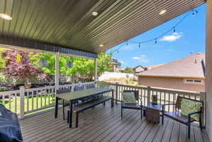 Spacious covered deck featuring composite decking and white railing, ideal for outdoor living