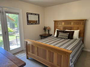 Main floor bedroom with access to patio and hot tub