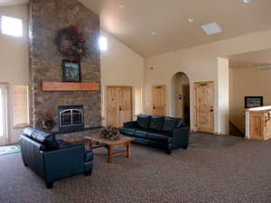 Spacious common area featuring a floor-to-ceiling stone fireplace, sitting area and serving space. This can be rented out.