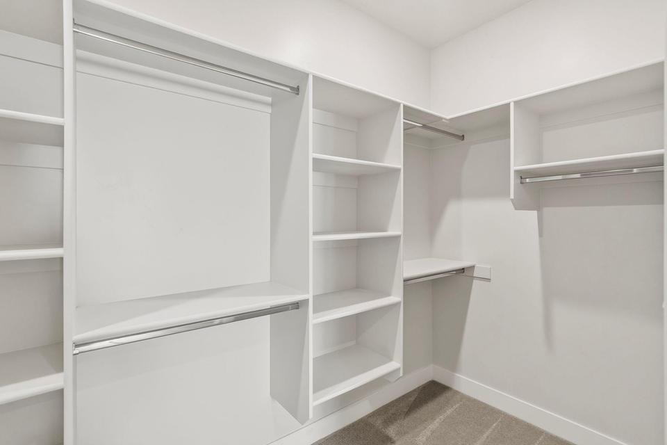Built-in closet system with multiple shelving units and hanging rods