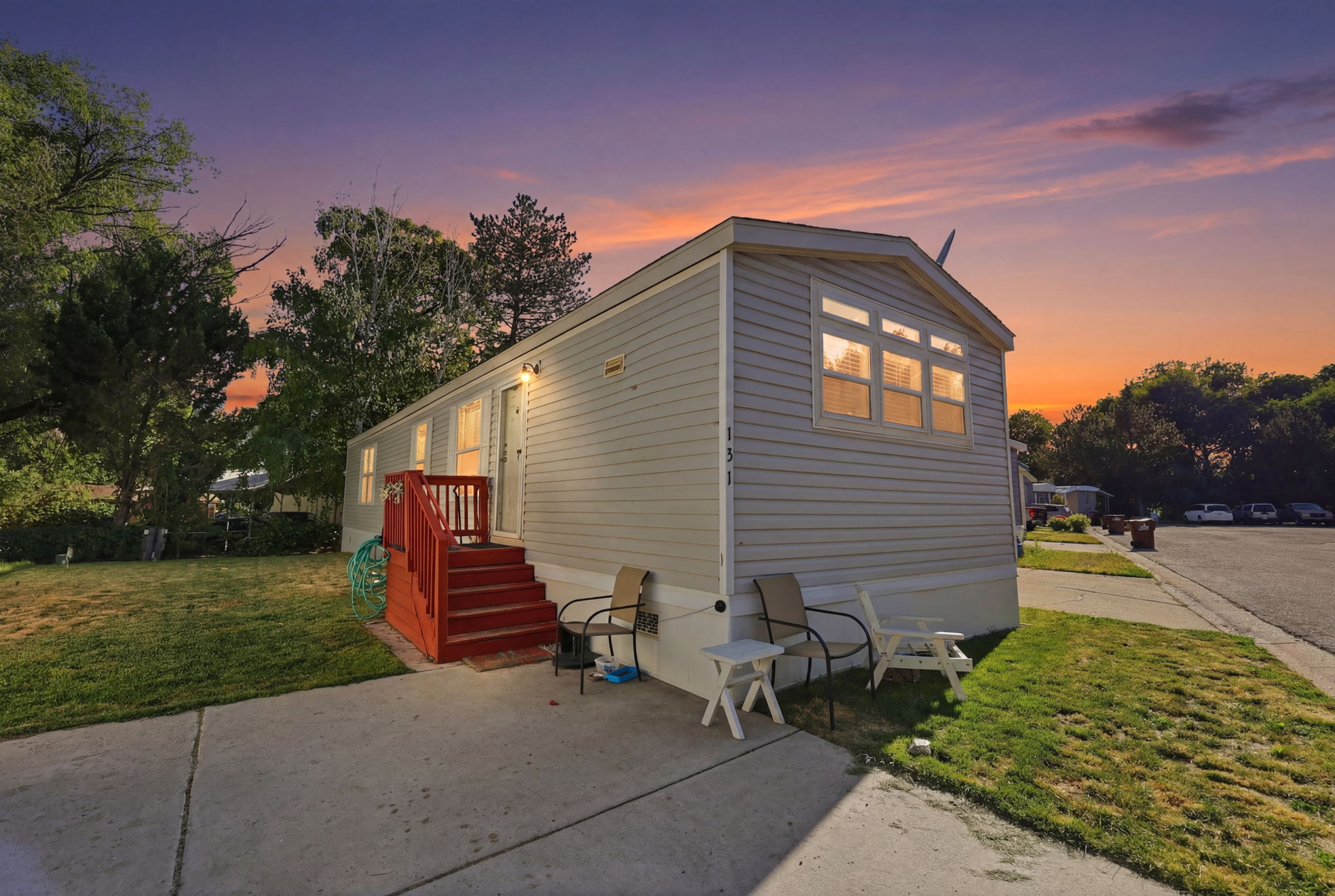 Property exterior with light-colored siding and a red-painted entry deck