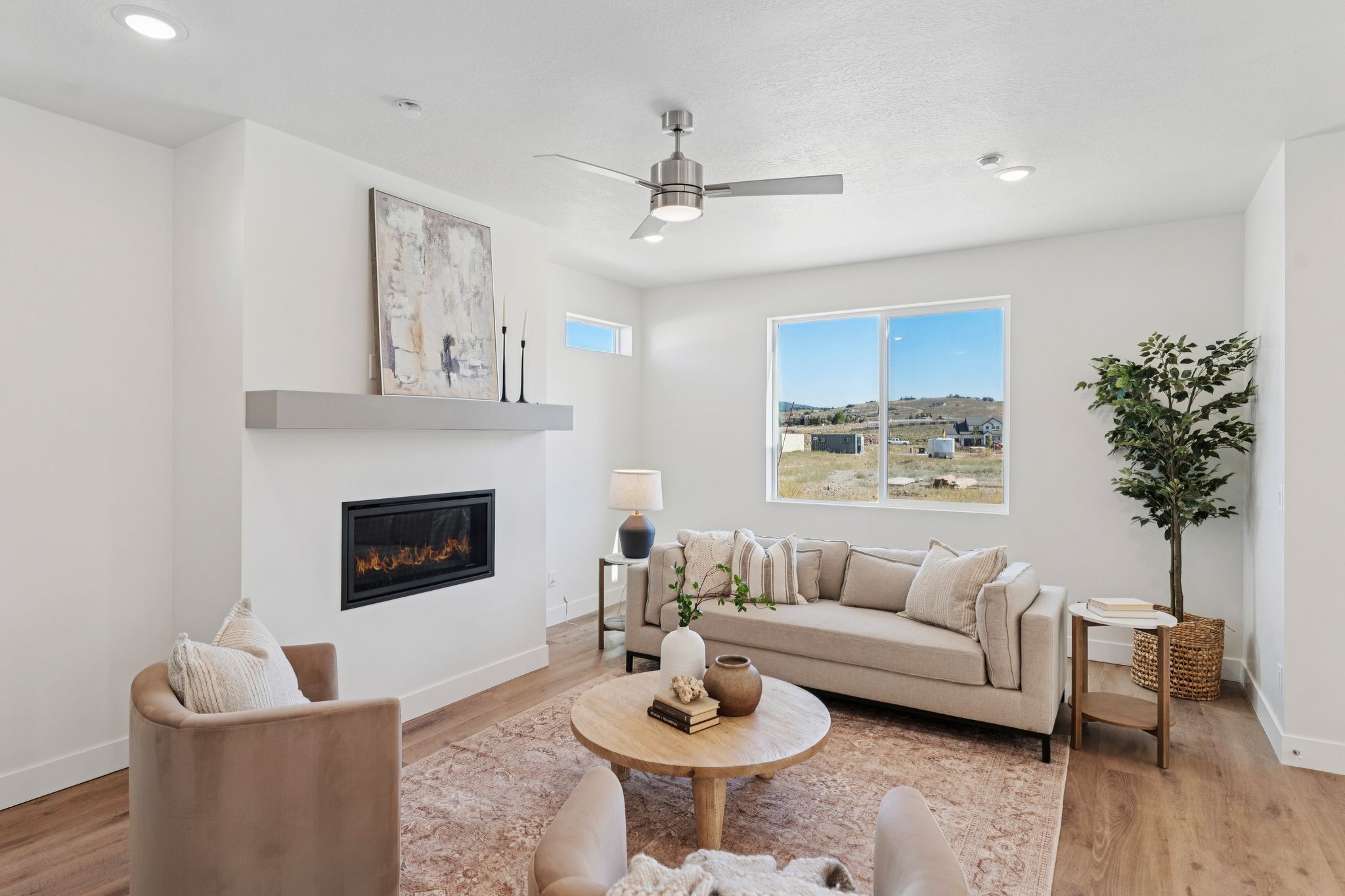Living area featuring wood-finish flooring, recessed lighting, and a ceiling fan
