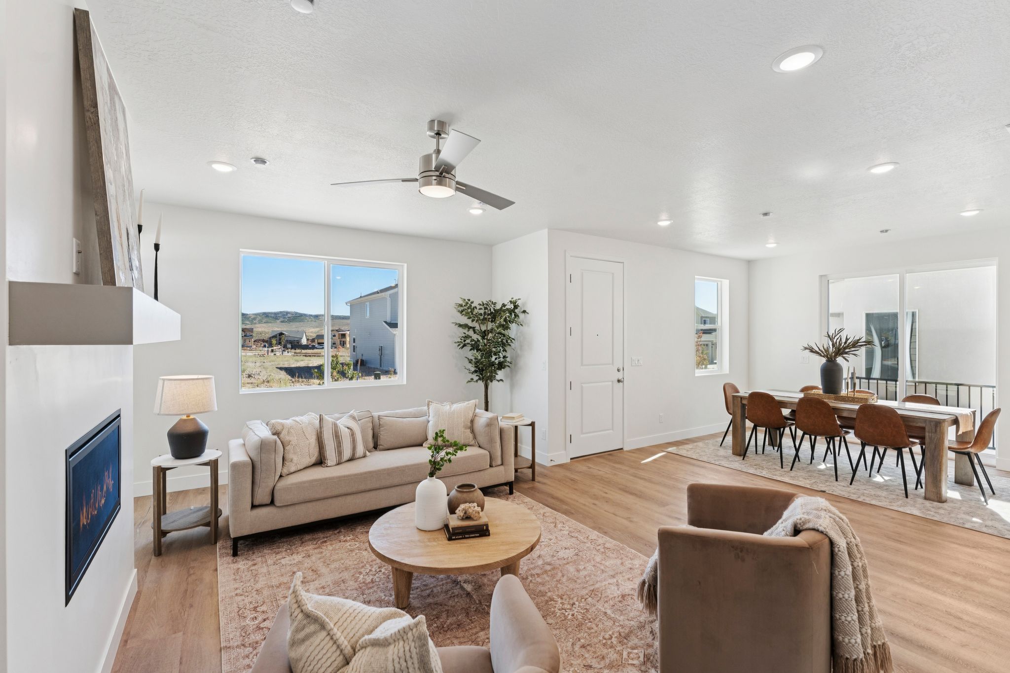 Open-concept living and dining areas featuring wood-finish flooring