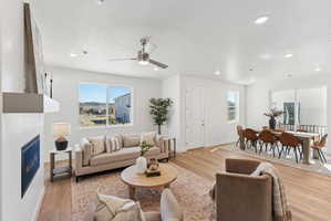 Open-concept living and dining areas featuring wood-finish flooring