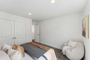 Carpeted bedroom with recessed lighting and white bi-fold closet doors