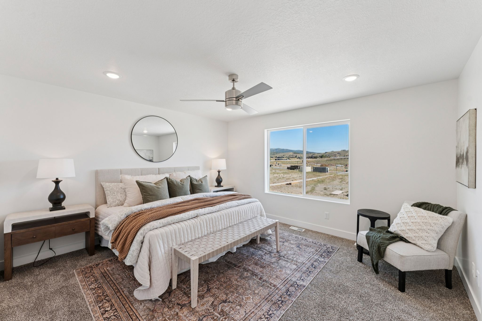 Spacious interior room featuring a large window, recessed lighting, and a ceiling fan