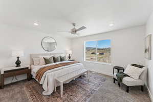 Spacious interior room featuring a large window, recessed lighting, and a ceiling fan
