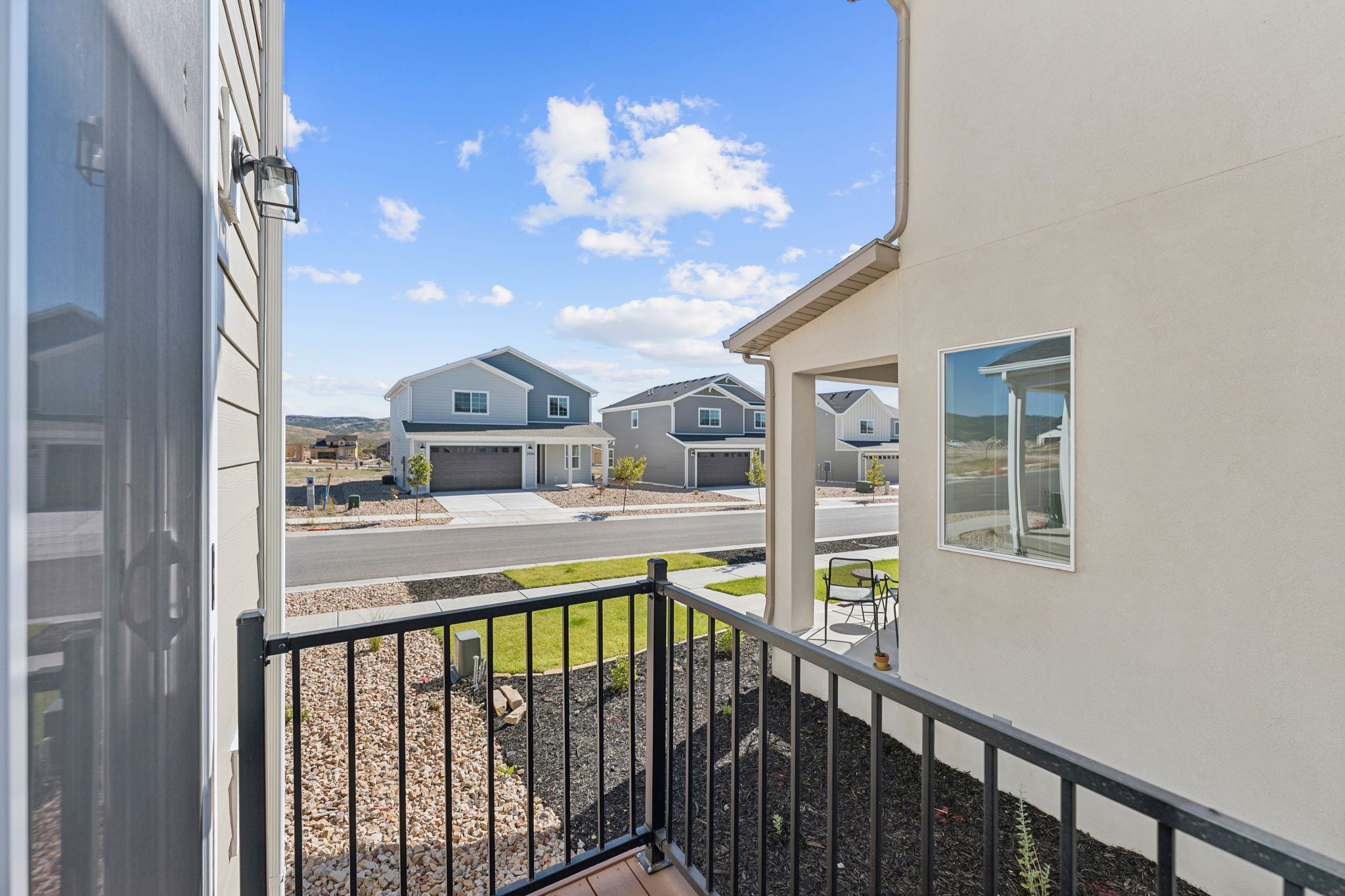 Balcony with black metal railing and wood-finish flooring