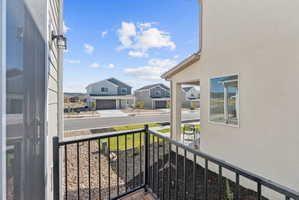 Balcony with black metal railing and wood-finish flooring